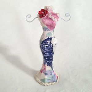 Jewelry stand/holder porcelain manican in a floral detailed dress. Two prongs.